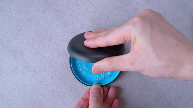 Opening blue dental aligner case that are  orthodontic mouthpiece storage in marble background.
