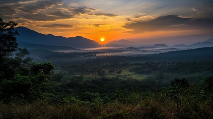 Sunrise over a valley nestled between mountain ranges.