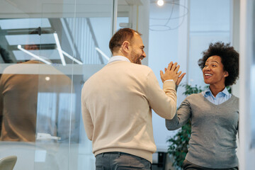 Colleagues giving five during a work break