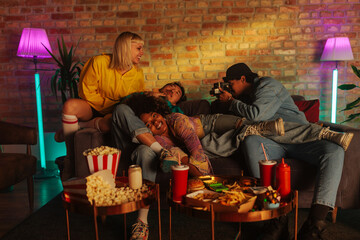 Friends taking polaroid indoors.
