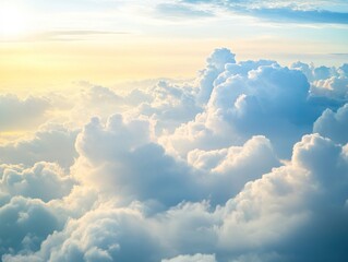 High-altitude view of fluffy clouds illuminated by golden sunlight