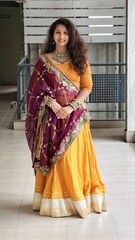 Woman dressed in traditional Indian attire with embroidered dupatta and oxidized jewelry, posing gracefully in ethnic Navratri outfit, for playing garba. chaniya choli with golden lagdi patta laces 