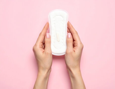 Hands holding a menstrual pad