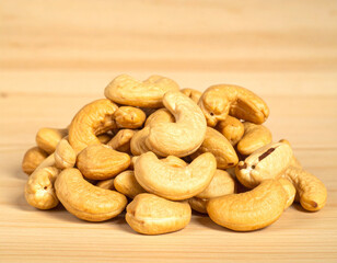 Fototapeta premium Roasted Cashew Nuts Pile on Wooden Background