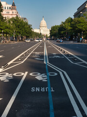 United States Capitol Building from the Street - The U.S. Capitol Building seen from a wide street with bike lanes and trees on a sunny day in Washington, D.C. © jmag.foto