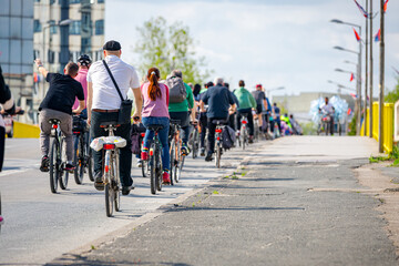 Group of cyclists on city road, street, asphalt