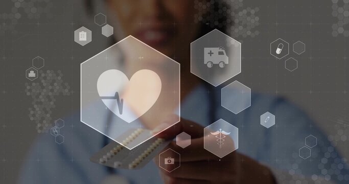 Woman in scrubs with stethoscope holding blister pack and floating hex icons in clinic