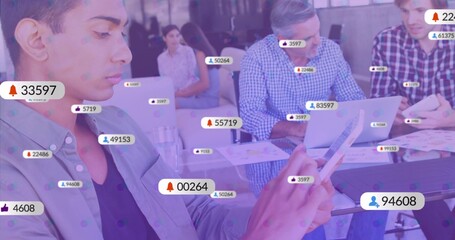 Working colleagues tapping tablet and laptops around conference table with notification icons