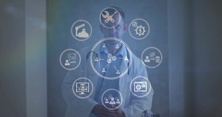 Operating scientist wearing lab coat in hall, displaying tools network data icons on digital panel