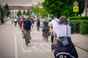 Group of cyclists on city road, street, asphalt