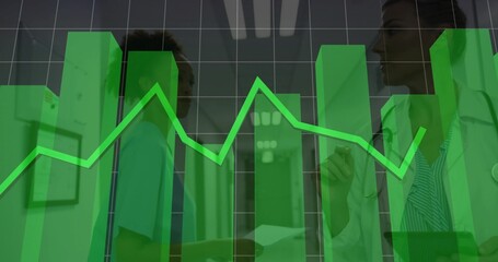 Reviewing patient data two medics consulting in ward corridor, with stethoscope, tablet and charts