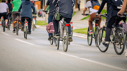 Group of cyclists on city road, street, asphalt