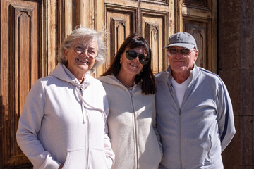 Happy senior Caucasian friends standing outdoors on an outing, enjoying each other's company. A group of smiling seniors and a concept of retirement lifestyle.