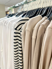 clothes on hangers in a store.