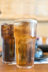 Refreshing iced tea and soft drink on wood tabe at restaurant