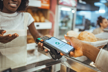Contactless Mobile Payment at a Bakery Checkout Counter with Customer and Clerk