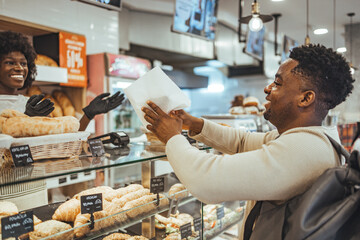 Customer Receiving Fresh Baked Bread at a Modern Artisan Bakery Counter