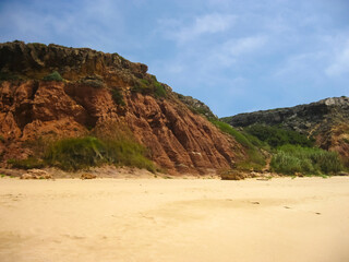A beautiful sandy beach featuring a stunning cliff in the background