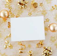 Christmas card blank mockup with copy space, xmas gold decor top view flatlay on beige background.  Greeting card.Christmas, New Year 