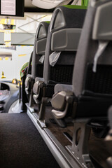 Inside a bus, empty seats are arranged in neat rows. The bright interior includes clean fabrics and visible space, creating a welcoming atmosphere for passengers
