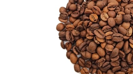 Top view of a pile of roasted coffee beans used for preparing authentic Greek, Turkish or Arabic coffee, isolated on white background with space for text.