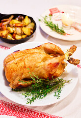 Whole Roast Chicken with Herbs and Roasted Vegetables on Festive Table