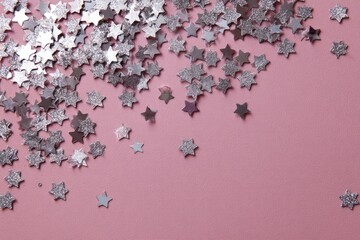 Silver star confetti on a pink backdrop