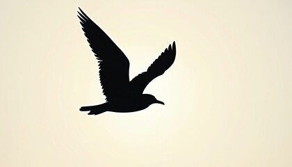 Obraz premium Silhouette of black seagull in flight against pale, soft background. Bird wings spread wide, showing graceful form, smooth lines as glides through air. Minimalist wildlife design conveys freedom,