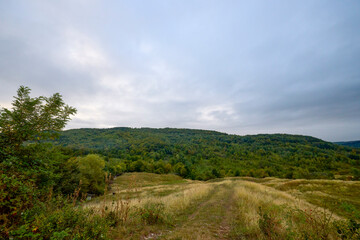 Obraz premium a beautiful mountain landscape in the Bucegi Mountains of Romania on a September day with clouds and fog.