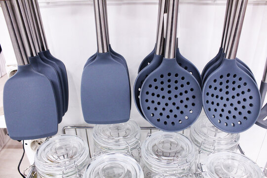plastic blades and gray slotted spoons close-up. Kitchen Set Accessories