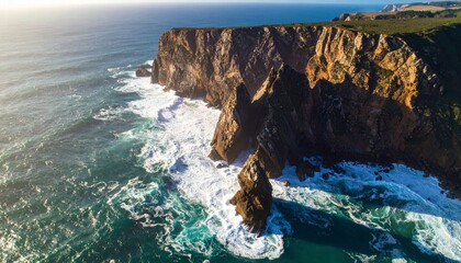 Aerial view of a coastal cliff with waves crashing below
