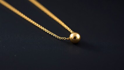 Fototapeta premium Elegant Closeup of a Minimalist Gold Necklace Against a Dark Background, Showcasing Delicate Design and Luxury Aesthetics