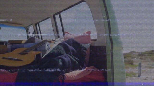 Static flickering starting camera panning and tilting camper focusing guitar for seaside ambiance