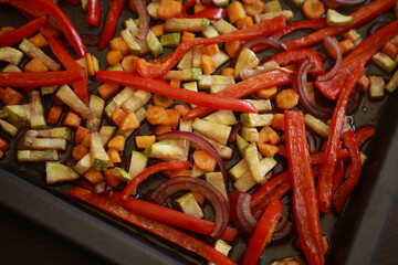 roasted zucchini, carrots, and red bell peppers on a baking tray