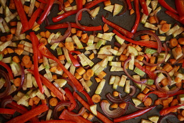 roasted zucchini, carrots, and red bell peppers on a baking tray
