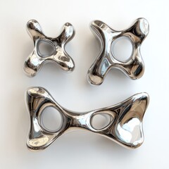Three polished metal sculptures, abstract forms