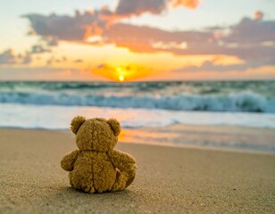 Teddy bear on beach at sunrise