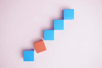 Geometric stacked blocks, featuring blue and orange, set against a calming pastel backdrop, symbolizing ideas of growth, structure, and creativity.