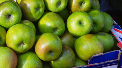 Fresh green apples stacked in market box