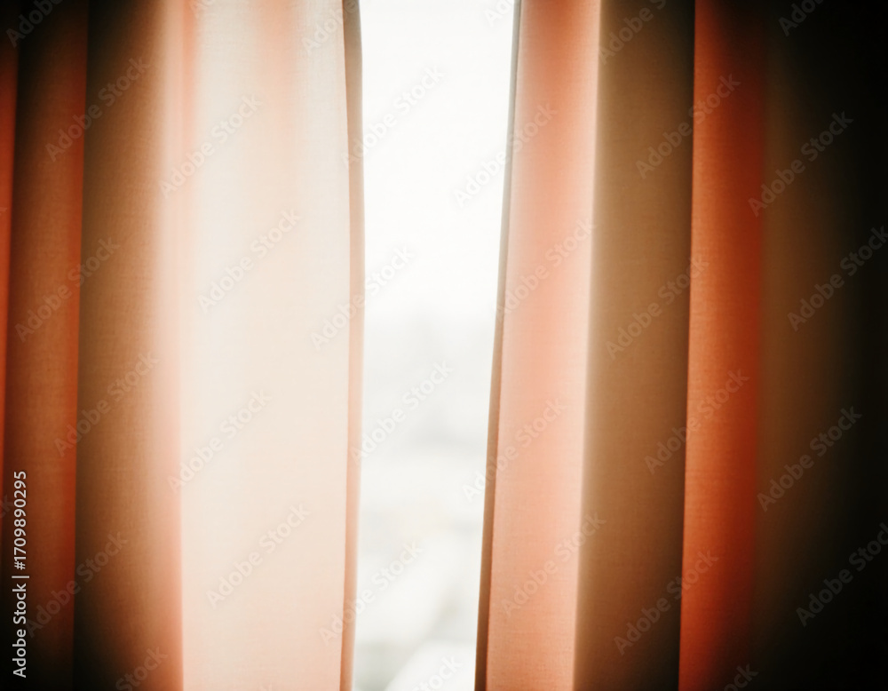 Poster soft light filters through the brown beige peach curtains, creating a warm atmosphere in a comfortab