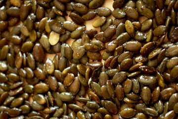 freshly baked pumpkin seeds lightly salted and arranged on a baking tray