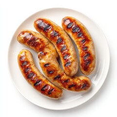 Four grilled sausages on a white plate
