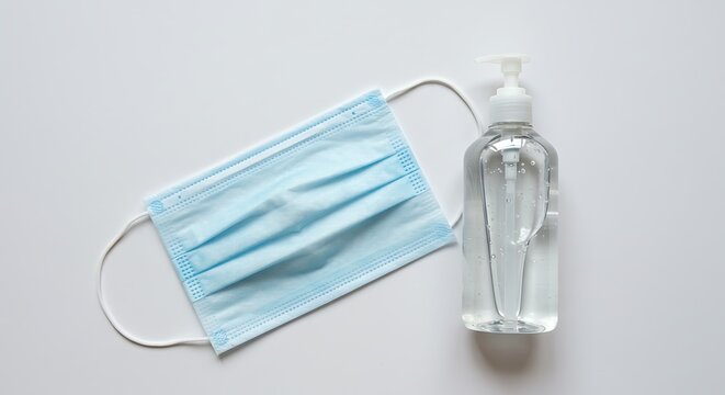 Surgical mask and hand sanitizer, essential hygiene items for personal protection and preventing the spread of germs - Powered by Adobe