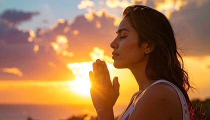 Woman meditating at sunset