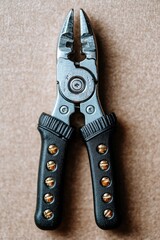 Metal pliers with black handles