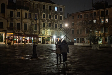 Obraz premium Menorah lights up Campo del Ghetto Nuovo during Hanukkah celebration