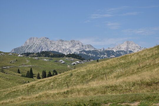 Velika Planina Pastures with Kamnik&ndash;Savinja Alps under Clear Summer Sky (Slovenia)