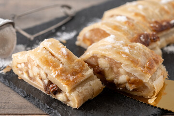 Homemade apple strudel on wooden table