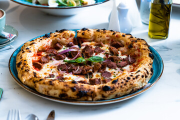 Pizza with salad and  juice on marble table Morocco September 3, 2025