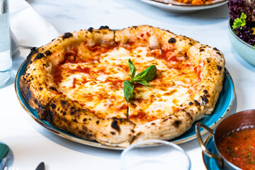 Pizza with salad and  juice on marble table Morocco September 3, 2025